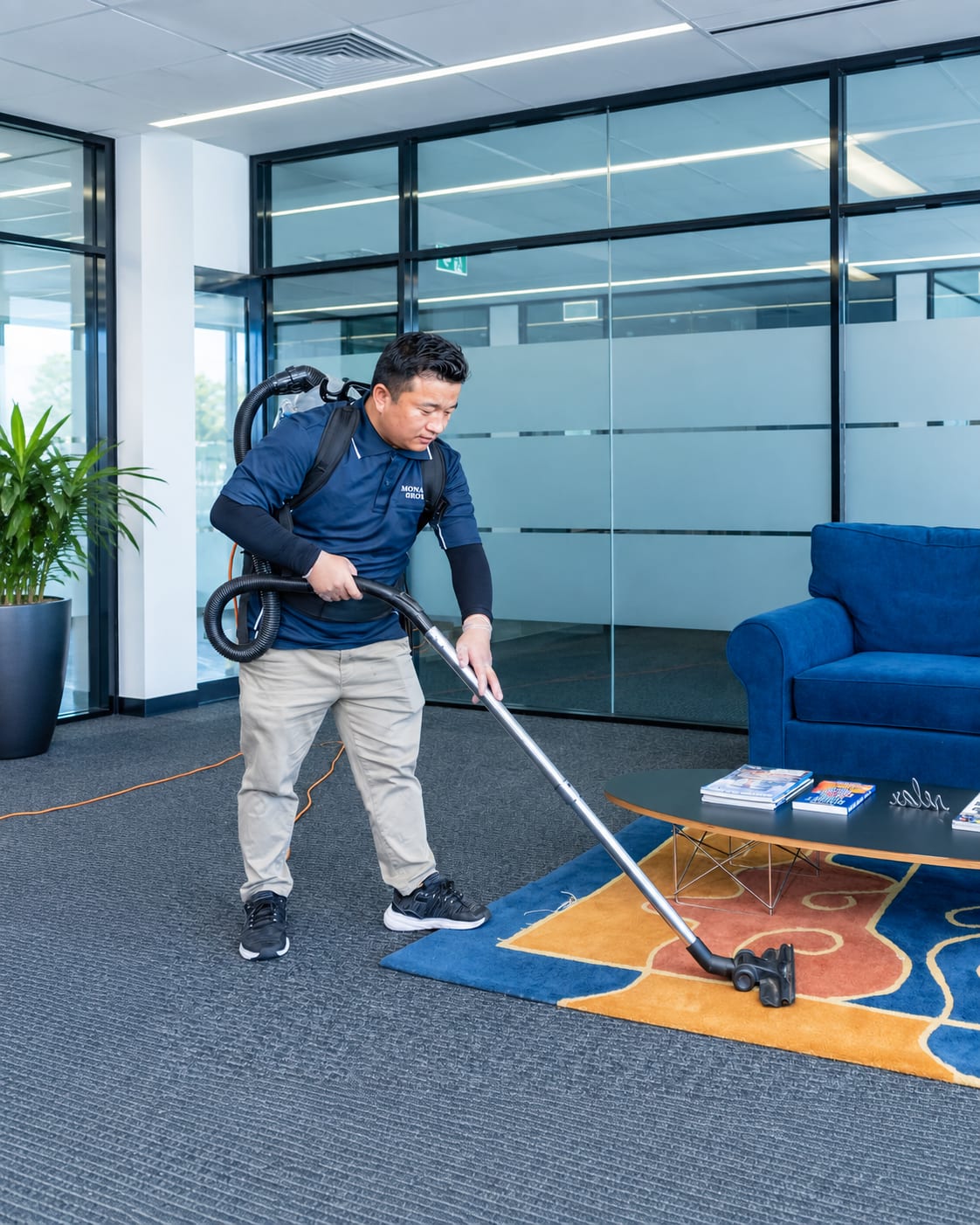 Monaro Group professional vacuuming a commercial office lounge